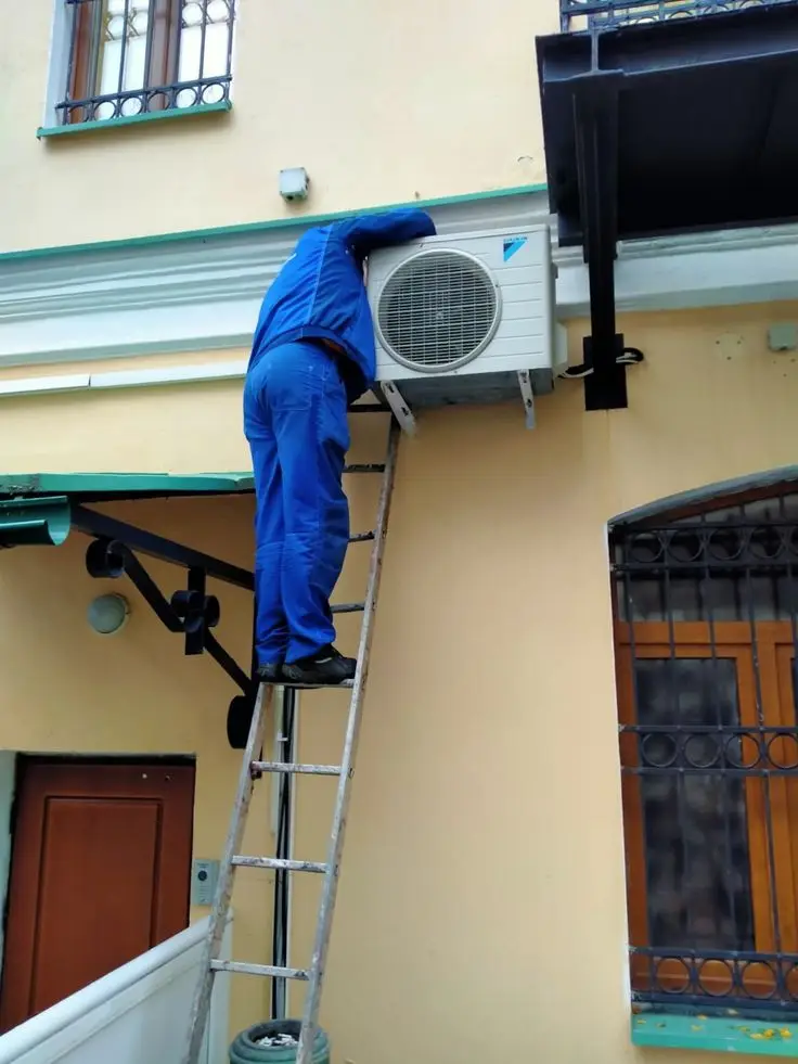 A man installing AC